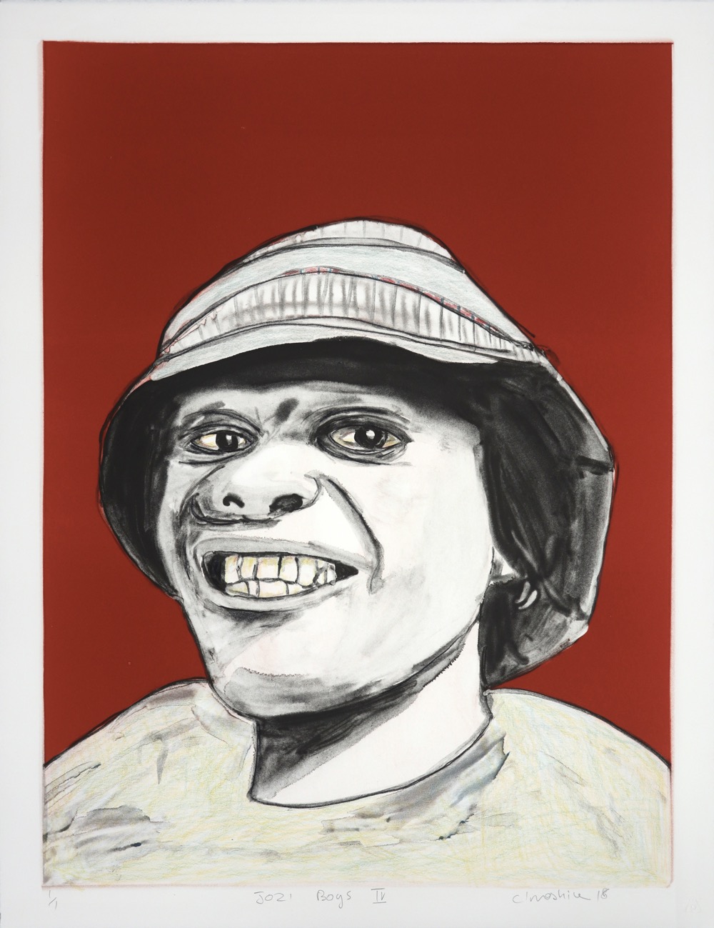 Smiling young man in bucket hat looking directly at the viewer.