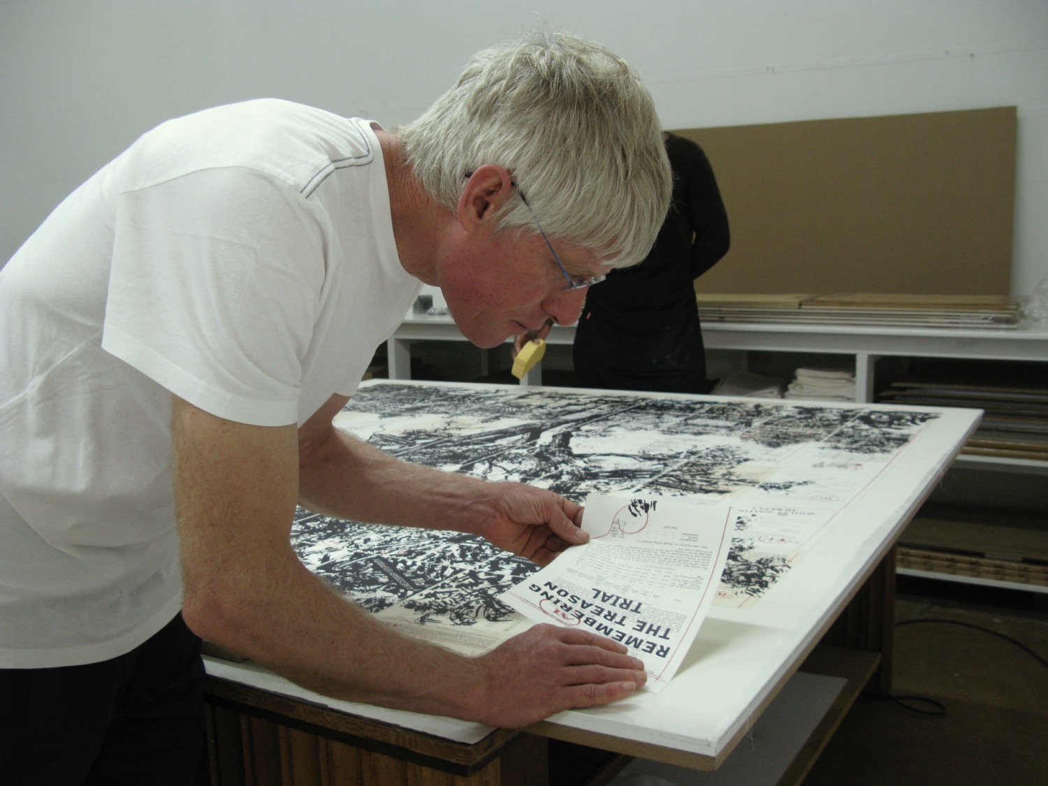 Mark Attwood glueing down a section of a print by William Kentridge.
