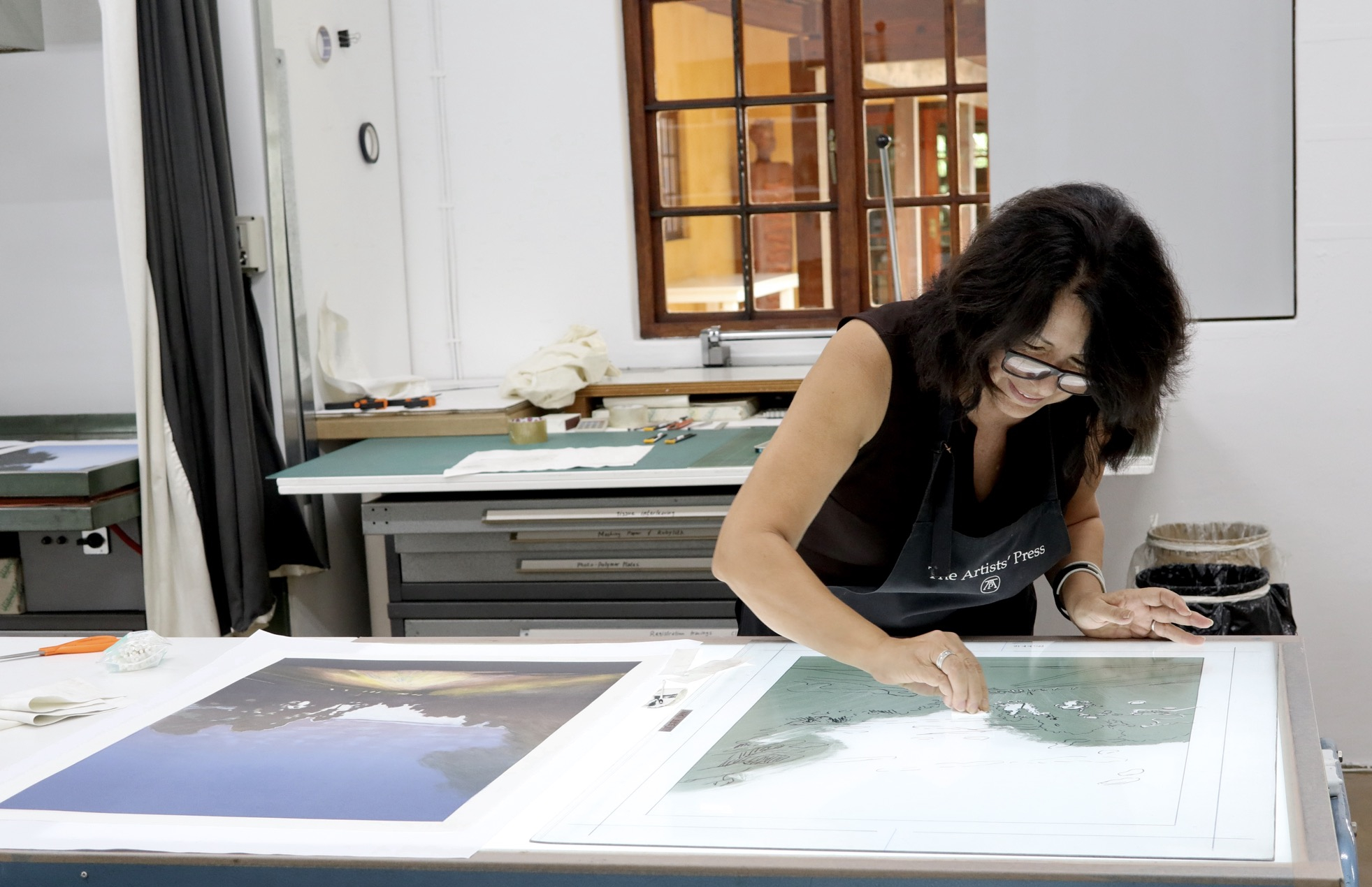 Maria Marais working on a monoprint plate at The Artists' Press