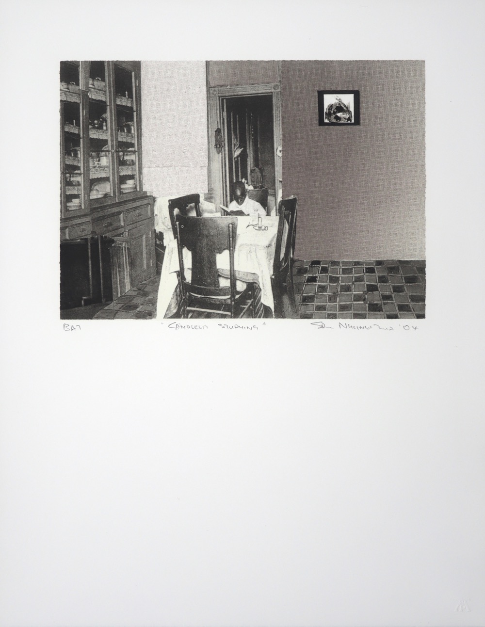 Dining room interior with a child sitting at a table studying by candle light