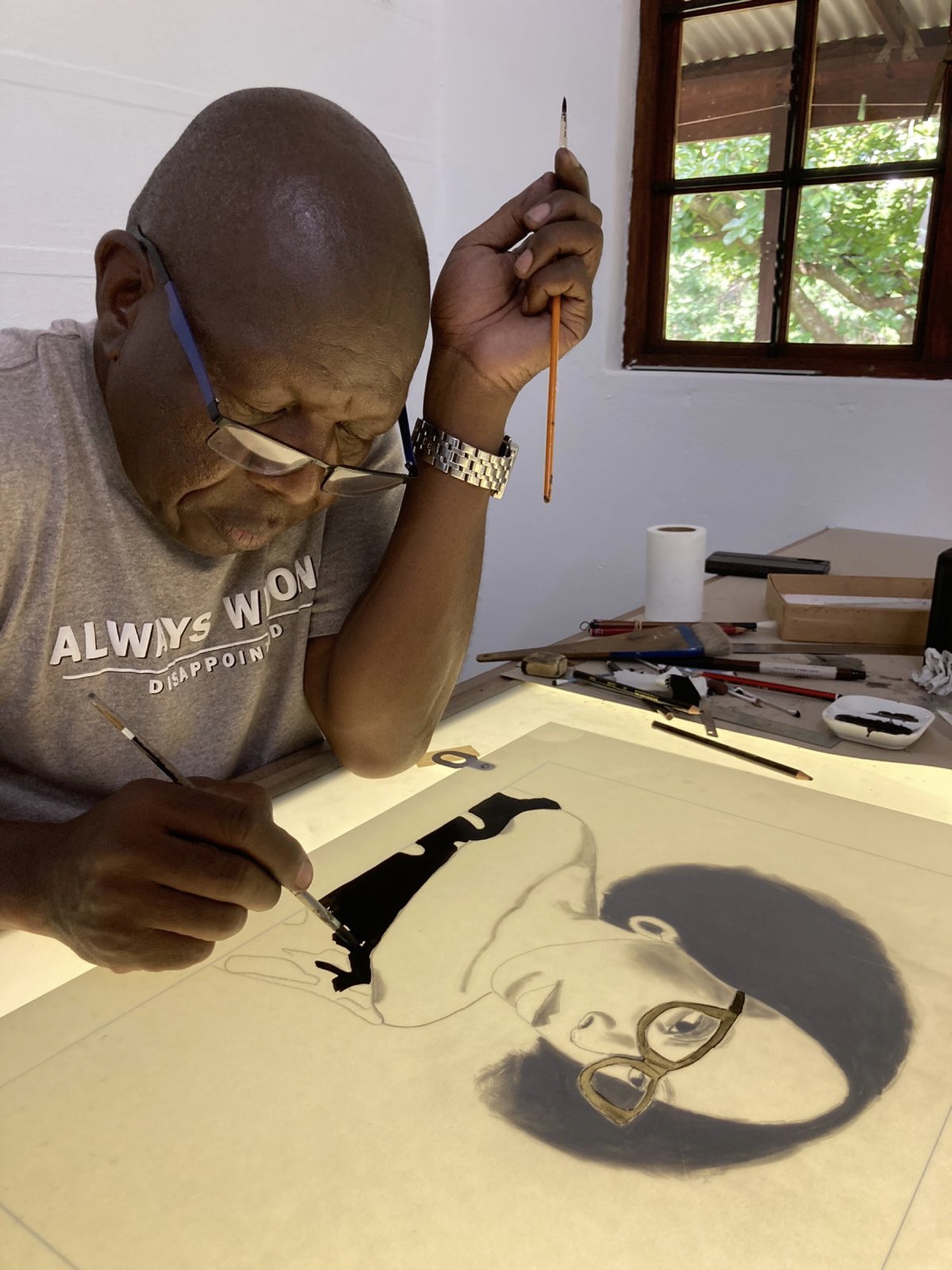 photograph of Sam Nhlengethwa drawing plates for Afro I