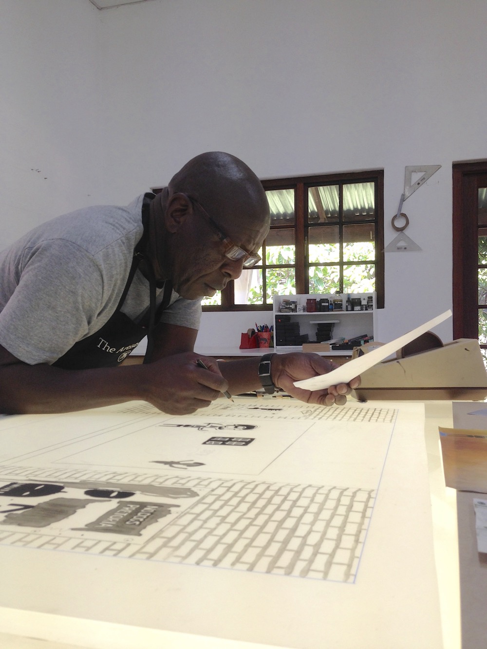 Sam Nhlengethwa working on film for a tribute print at The Artists' Press.