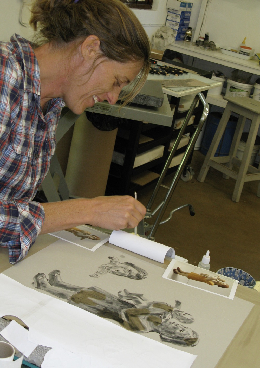 Claudette Schreuders painting onto a lithographic stone for her print titled "Eclipse".