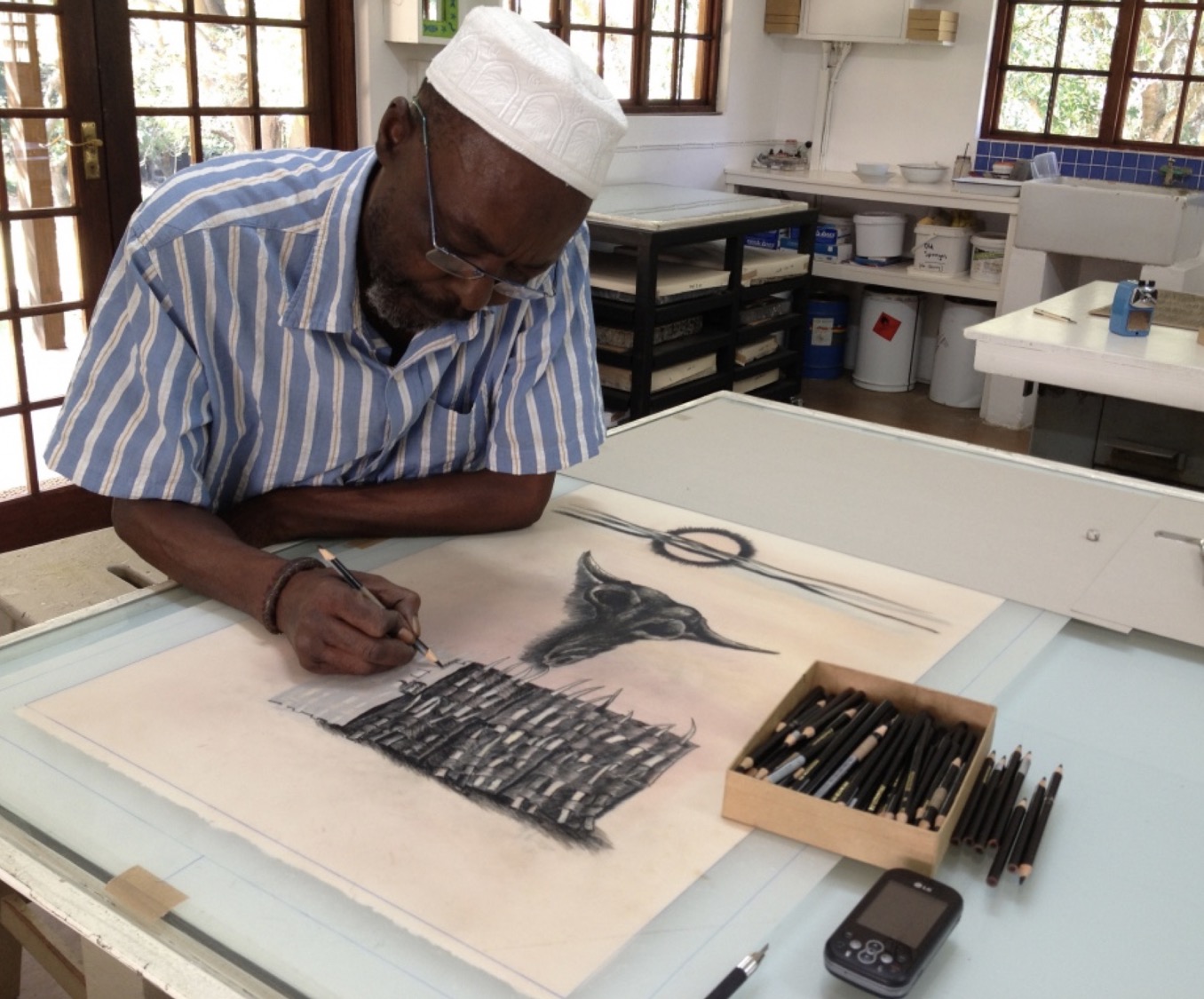 Dumisani Mabaso drawing onto grained film with litho crayon for a lithograph of his.
