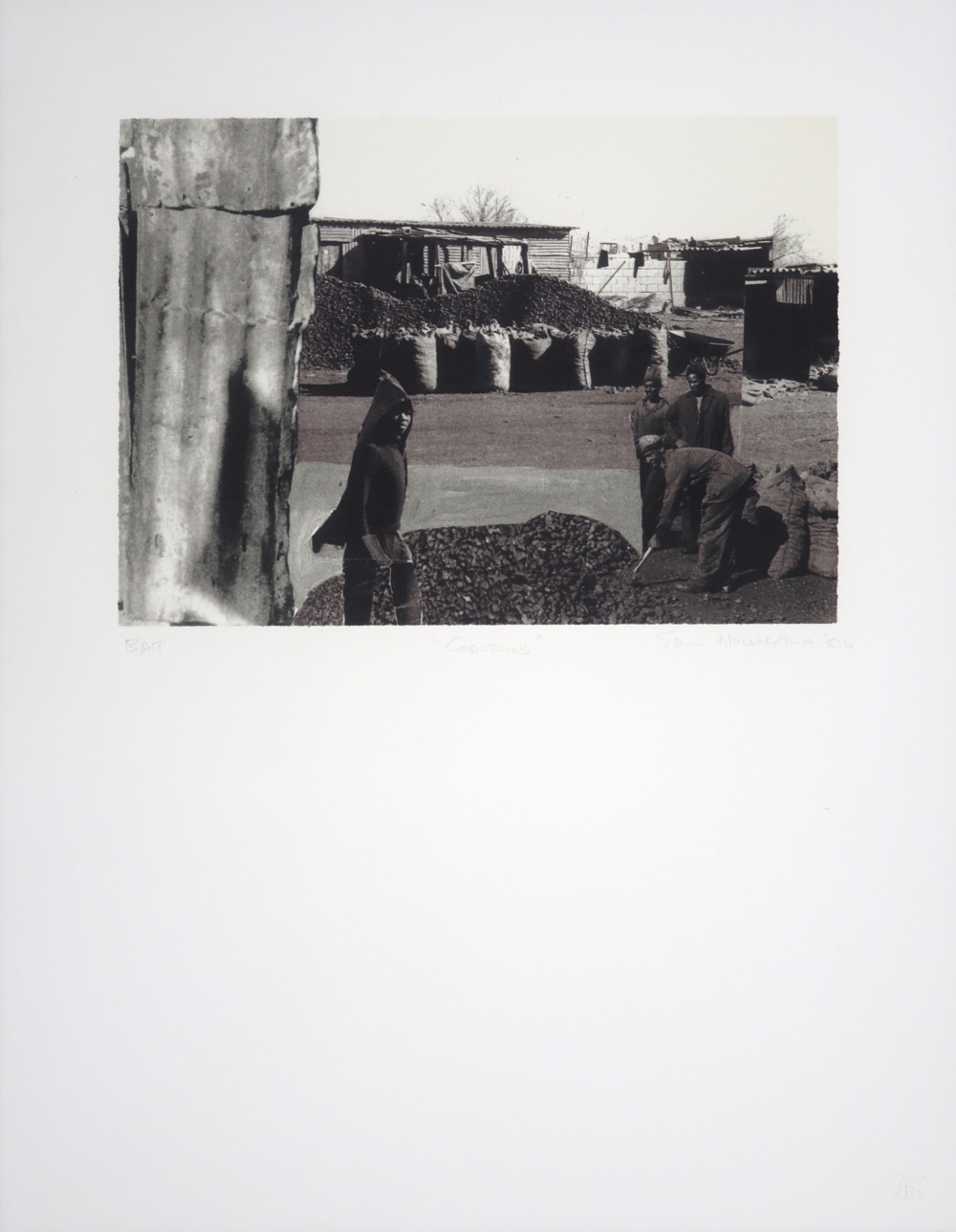 Coal yard scene with workers shovelling piles of coal Coal yard scene with workers shovelling piles of coal