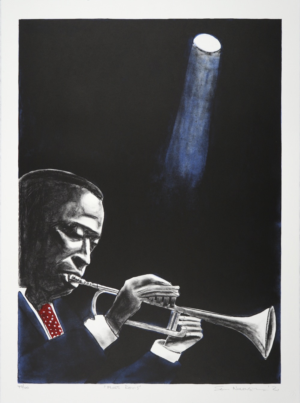 Miles Davis head and shoulders from the side playing the trumpet beneath a single spot light.