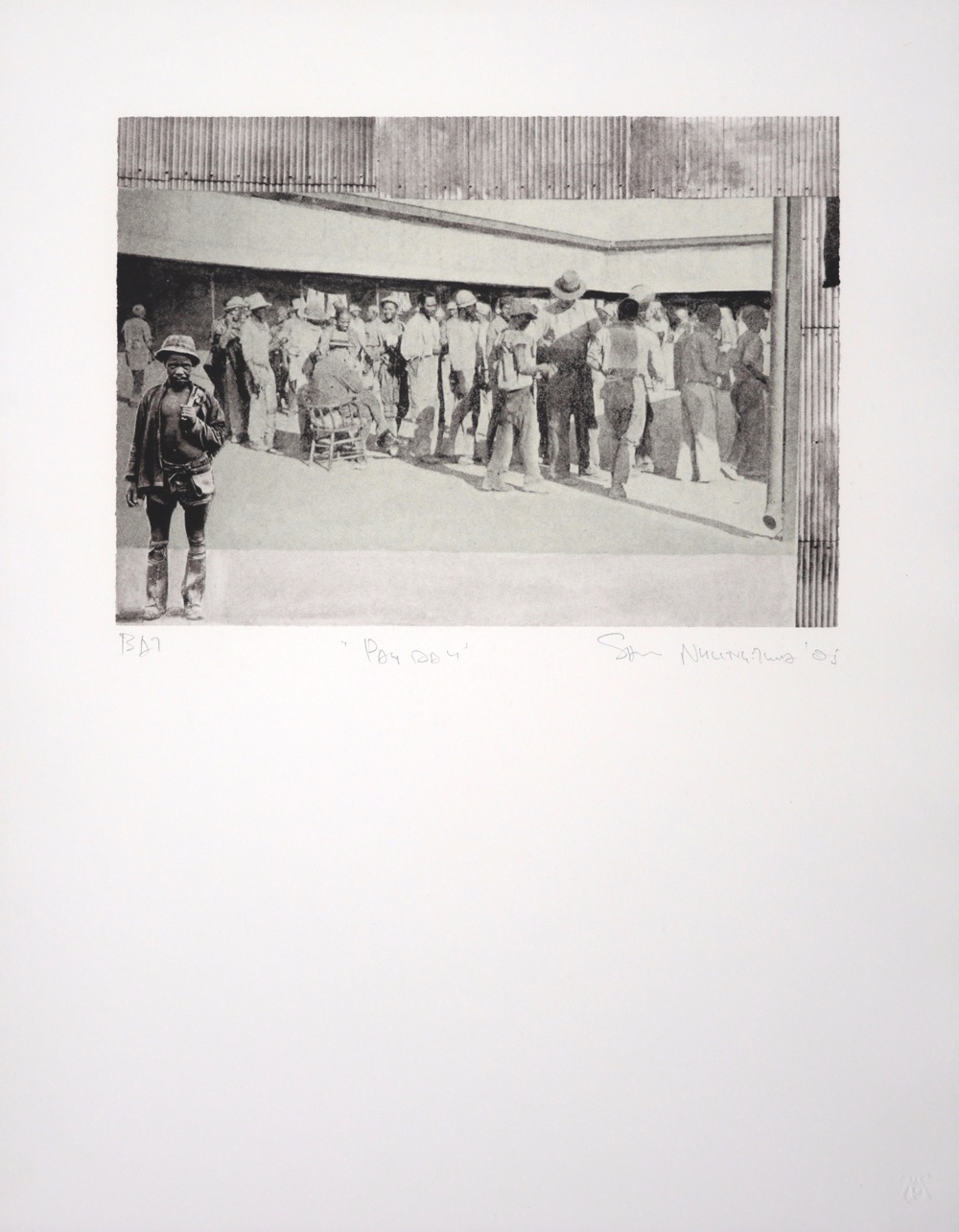 Miners waiting in line with corrugated iron wall behind them