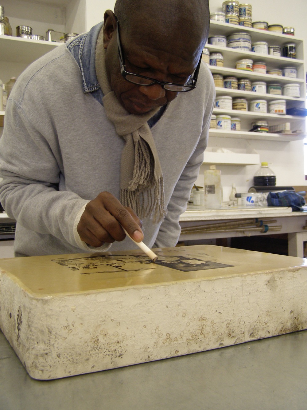 Sam Nhlengethwa drawing on a litho stone at The Artists' Press for his Restaurants print series